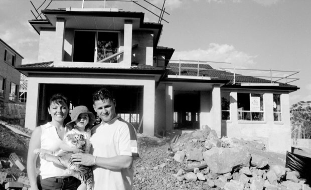 Family outside house construction zone